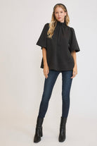 Umgee Bow Tie Back Mock Neck Half Sleeve Blouse in Black Shirts & Tops